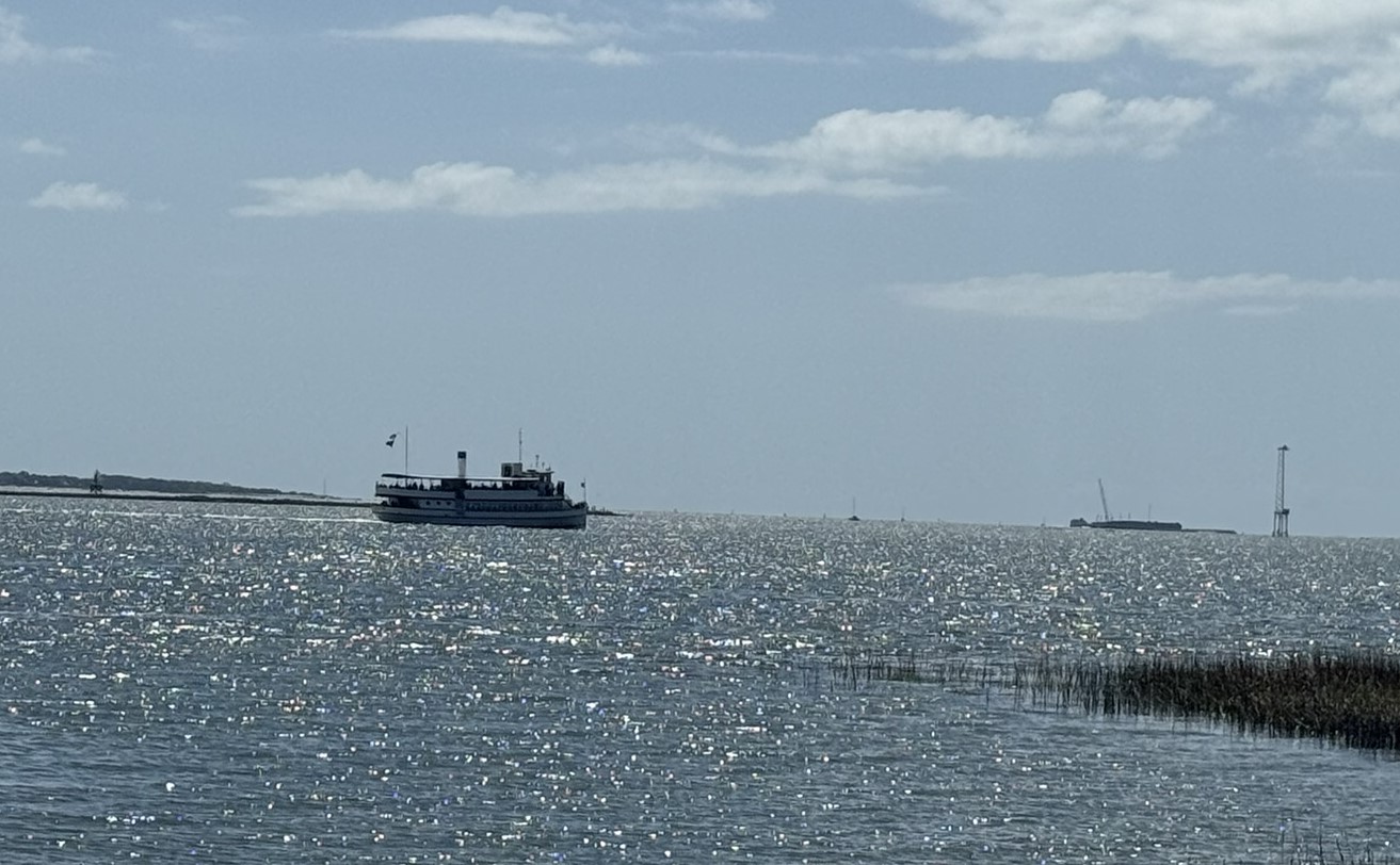 Ferry type boat in the bay on a sunny summer day heading towards Fort Sumter