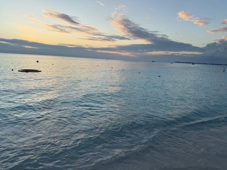 Beautiful sunset over the blue tranquil waters of Seven Mile Beach in things to do in the Cayman Islands