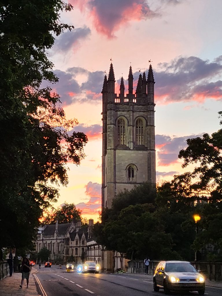 Oxford gardens tower at sunset from the street with a beautiful colorful sky