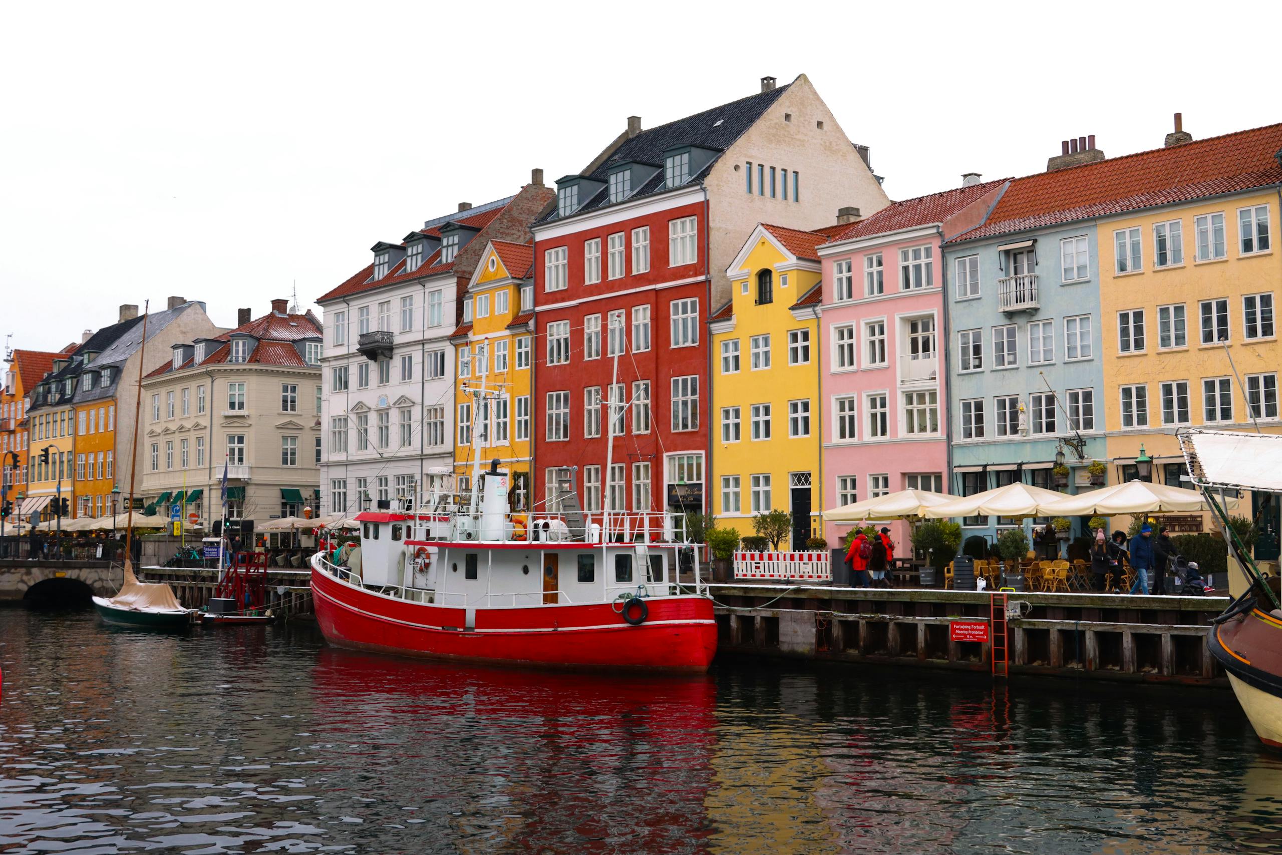 Brightly colored buildings line the iconic Nyhavn harbor in Copenhagen, unique experiences.