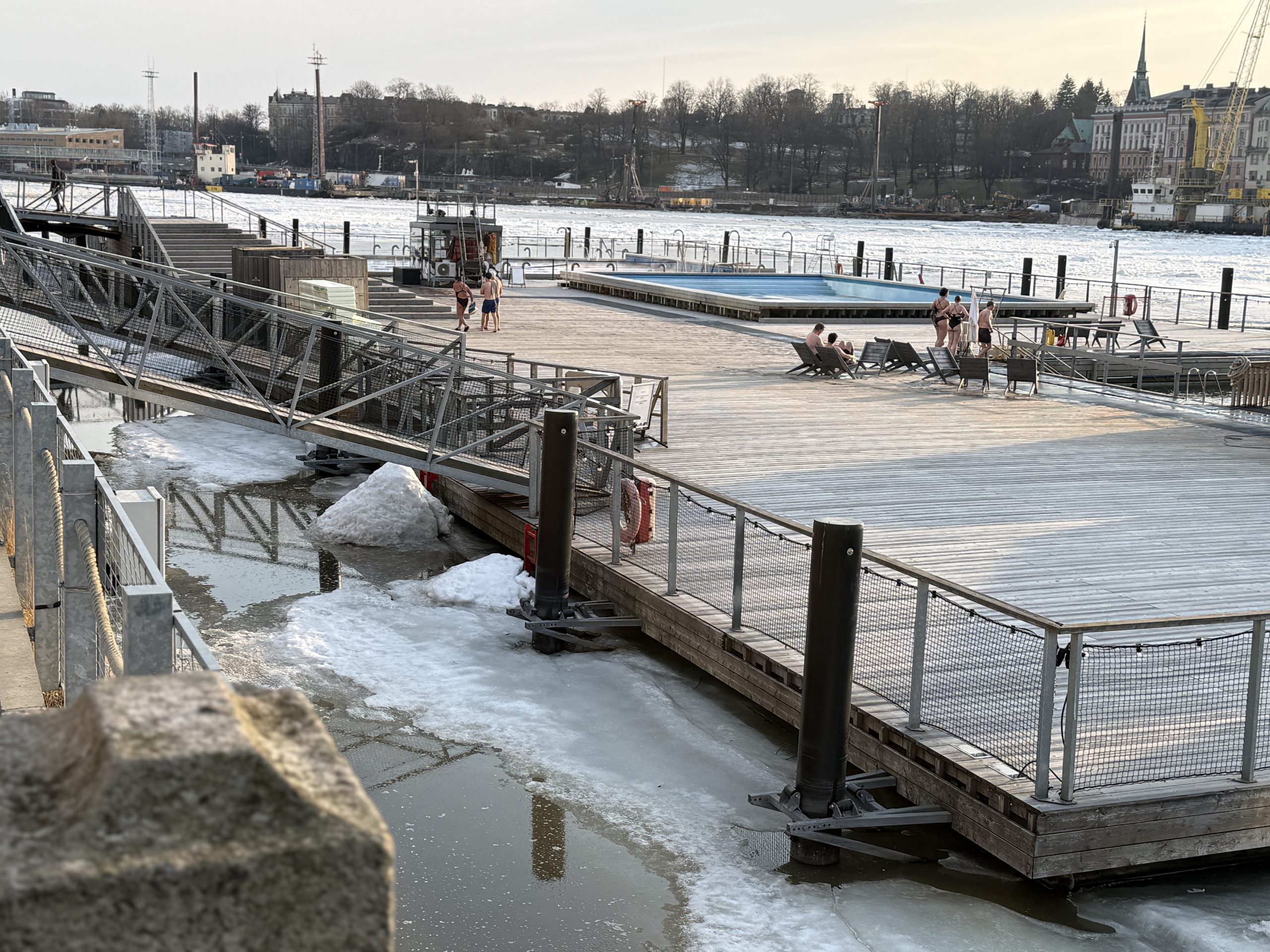 People walking from the sauna to the outdoor pools in March at the Alas Pool as seen in secret saunas of Helsinki