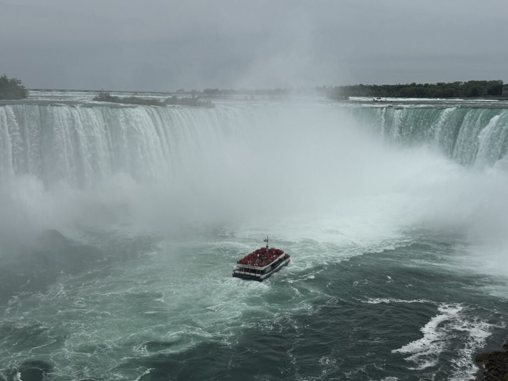Hornblower boat ride seen from the view of the falls as it approaches Niagara Falls in the ultimate guide to Niagara Falls
