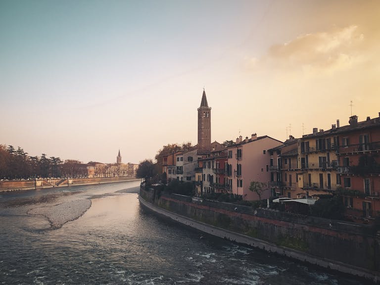 Charming sunset view over Verona, highlighting its historic architecture by the river on a Verona 2- day romantic itinerary.