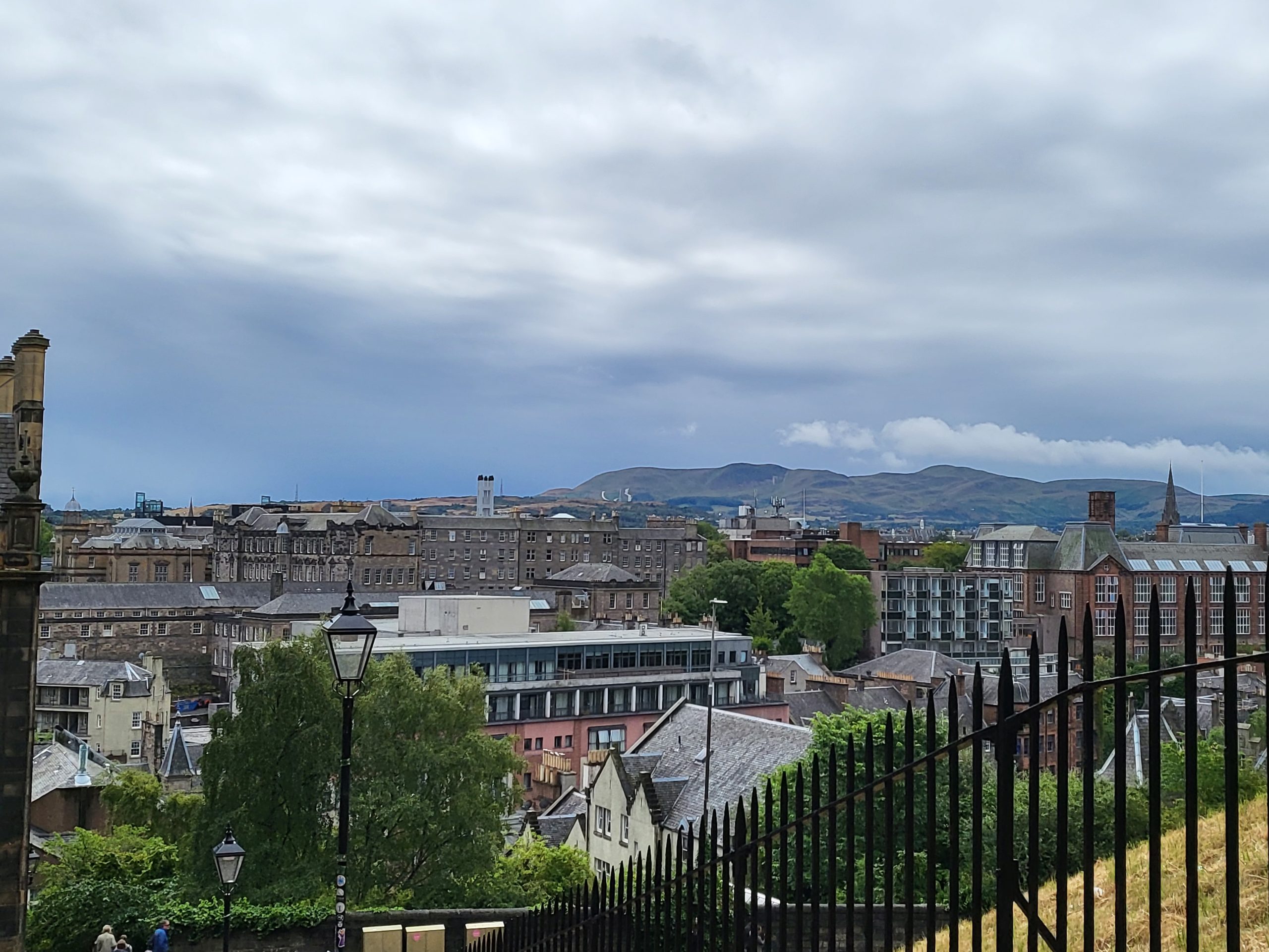 View of part of the city of Edinburgh with the mountains in the background on an overcast day
