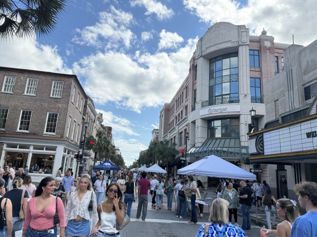 Second Sunday on King Street in Charleston, South Carolina. The street is closed off and filled with pedestrians, and merchants on the sides of the streets