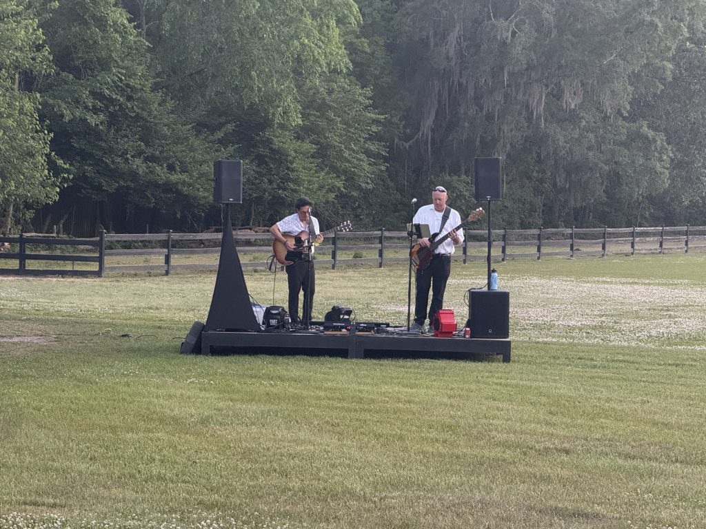 A band playing as the sun is low in the sky in Magnolia Plantation and Gardens in Charleston, SC at a wine stroll