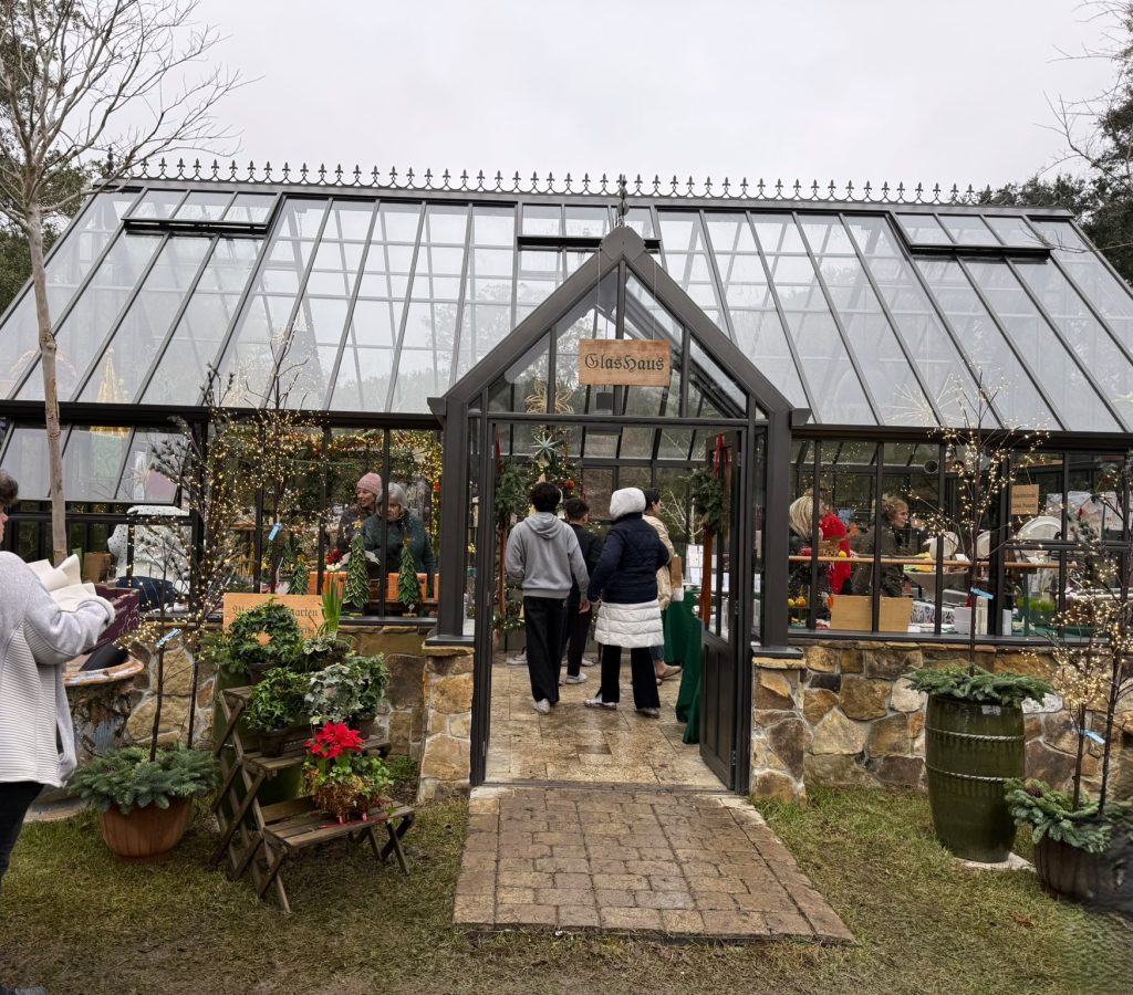 Christmas Market in Charleston glass house filled with people and a shop in the best Christmas events in Charleston