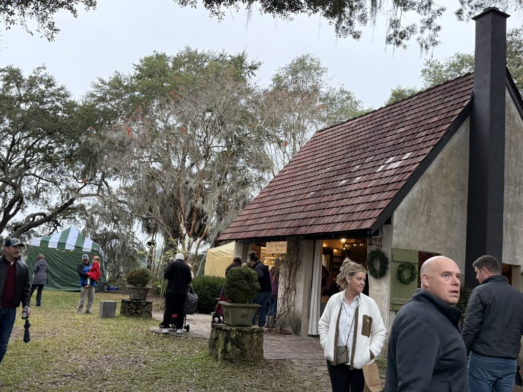 A neat looking building with people waiting to get inside in a Christmas Market in the best Christmas events in Charleston