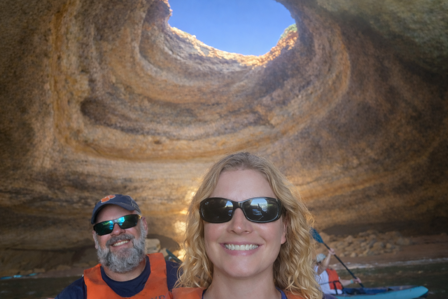 Casey and Mark of Wandering Everywhere taking a selfie while kayaking in the Benagil Caves in Algarve, Portugal on spring break in the Algarves