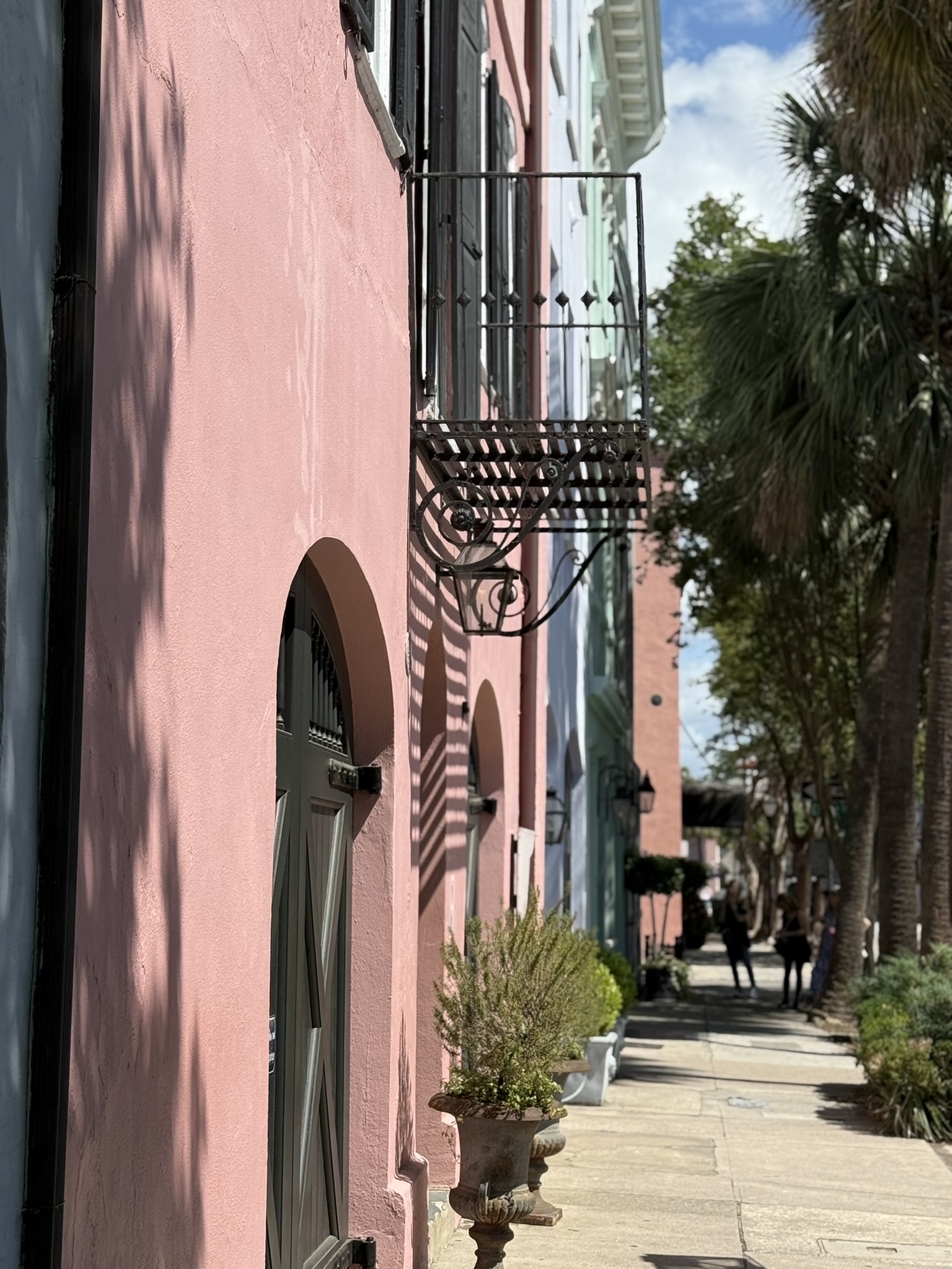 On East Bay Street during spring break in Charleston, SC looking down Rainbow row at the beautiful pink house