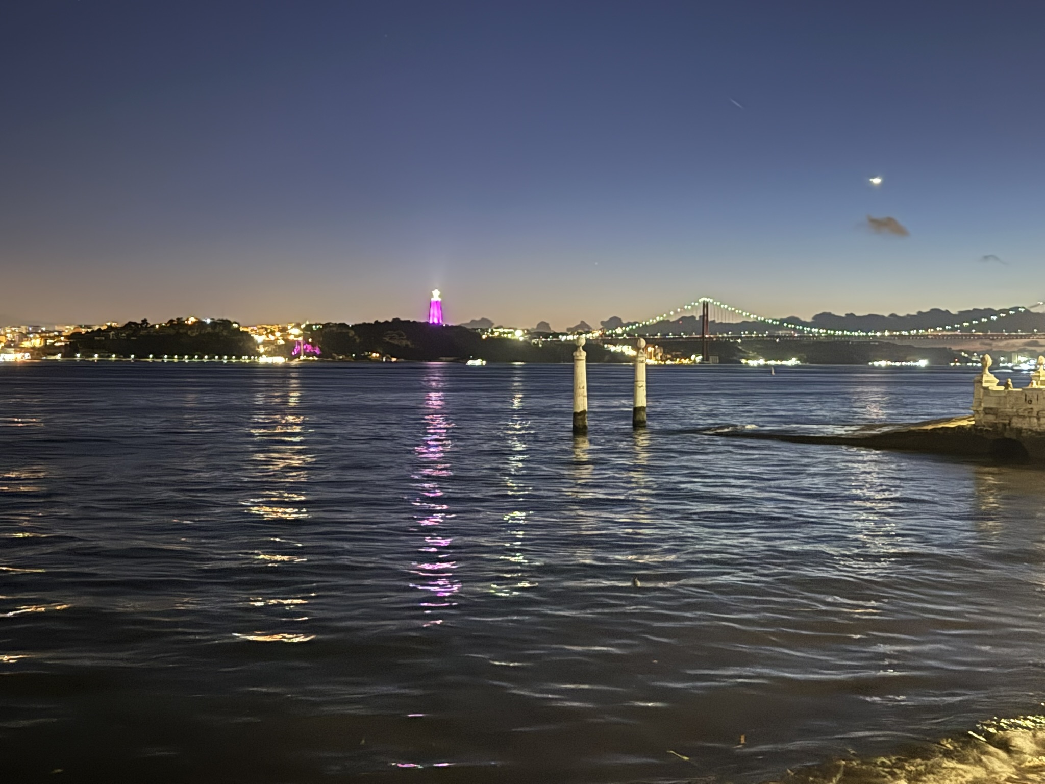 View of the Tagus river from Lisbon, Portugal just after the sun has set on a clear night as seen in best hotels in Lisbon for couples