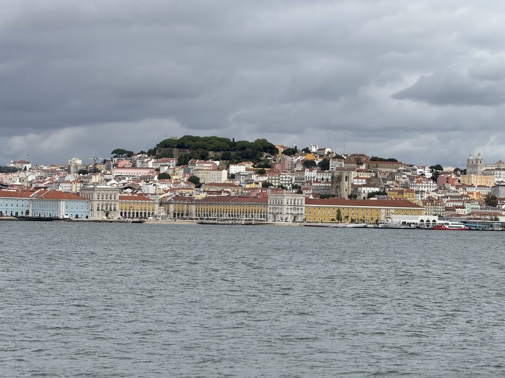 The city of Lisbon, Portugal as seen from the Tagus river on a cloudy day right before the rain starts in best hotels in Lisbon with river views