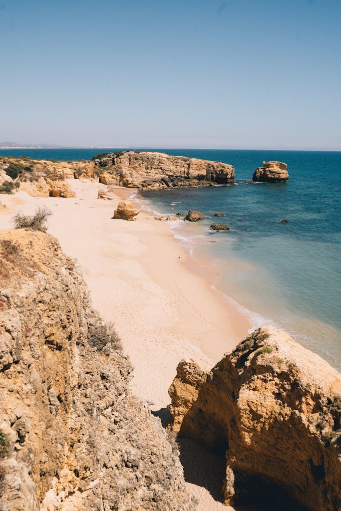 Explore the breathtaking rocky coastline of Praia da Marinha, Algarve, Portugal on a sunny day on spring break in the Algarve