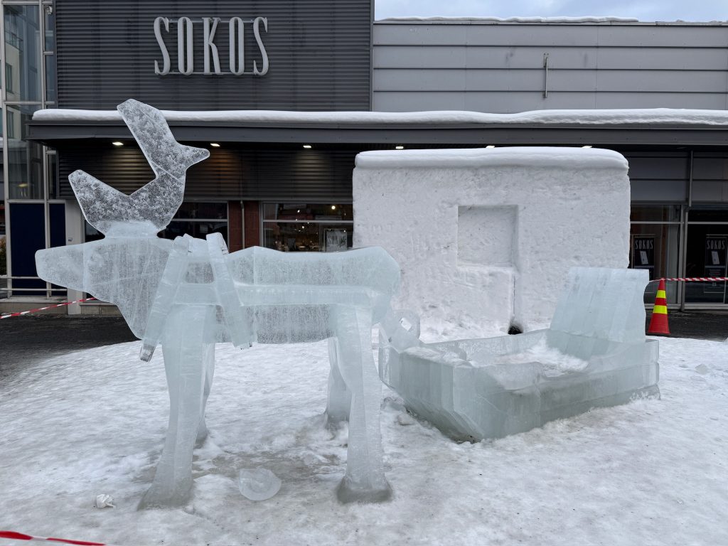 Life size reindeer made of ice in Rovaniemi as seen in the travel guide to Lapland