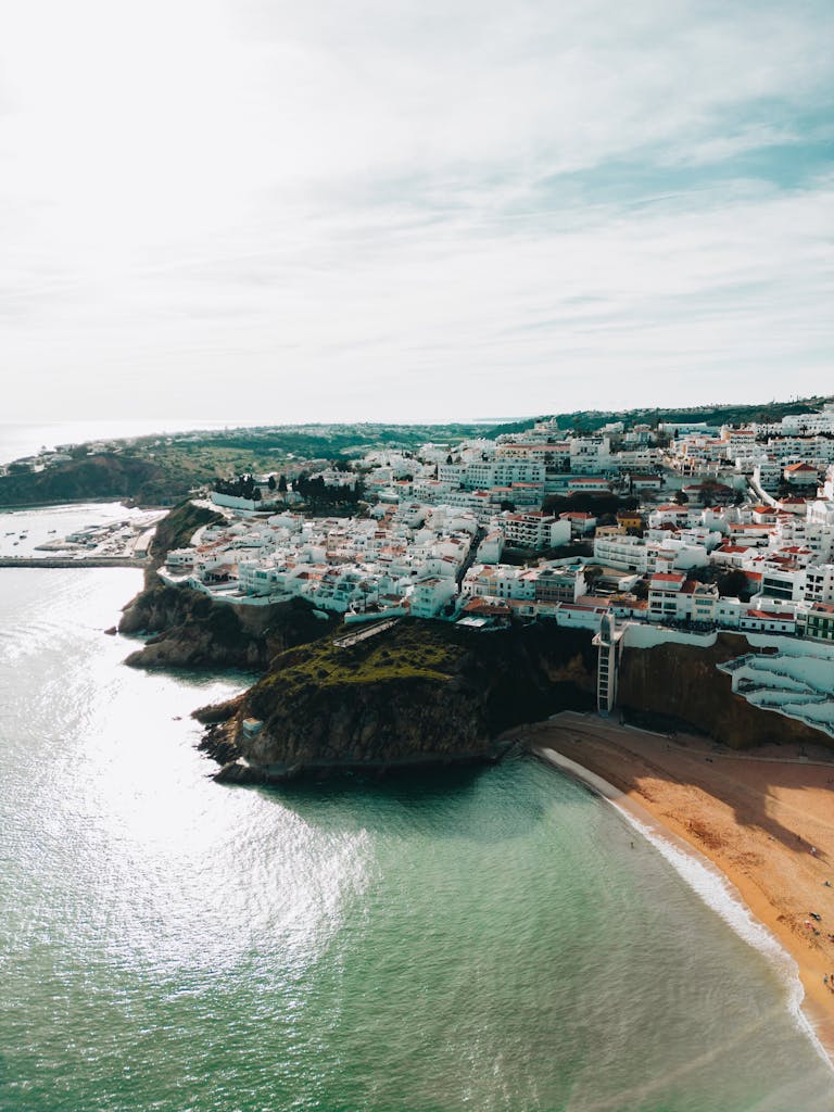 A breathtaking aerial view of Albufeira, Portugal's picturesque seaside town with cliffs and sandy beaches.