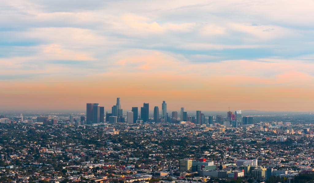 A breathtaking aerial view of downtown Los Angeles skyline at sunset, displaying urban architecture and vibrant colors for planning your LA 2028 Olympic trip