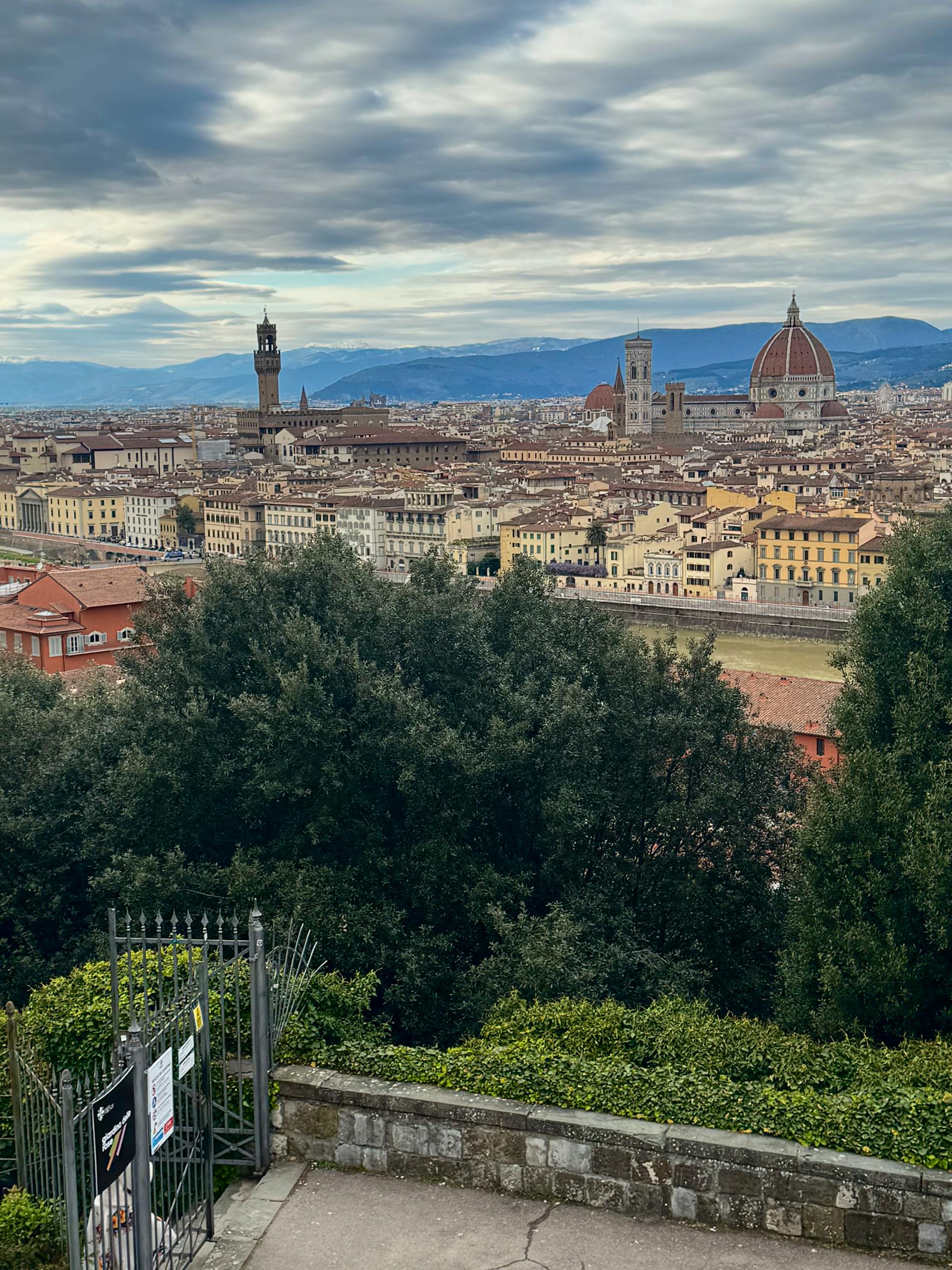 Aerial view of Florence with the iconic Duomo and cityscape under a dramatic sky in hidden gems in Florence