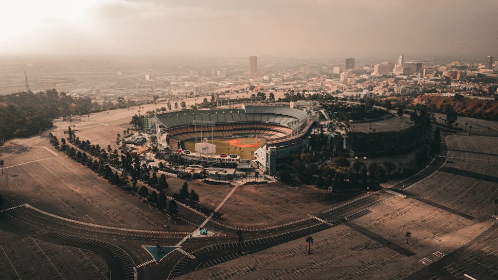 Captivating aerial view of Dodger Stadium and downtown Los Angeles under a dramatic sky in planning your LA 2028 Olympics trip