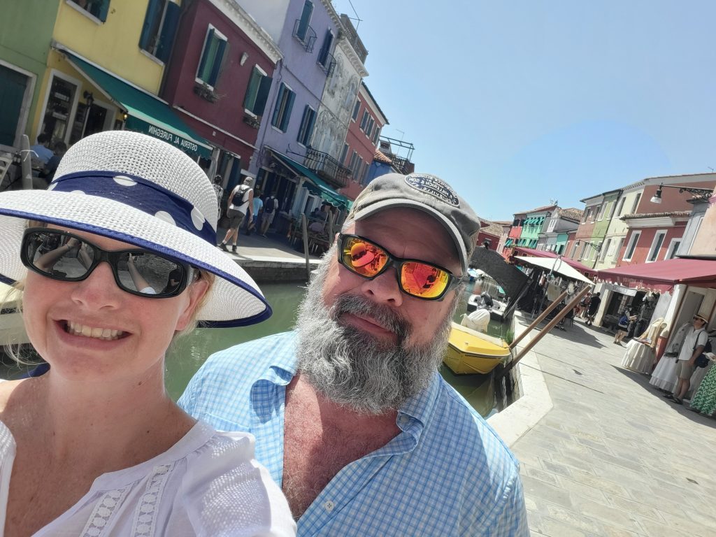 In preparing to write the travel tips blog post, Casey and Mark walking through Venice, Italy on a hot summer day
