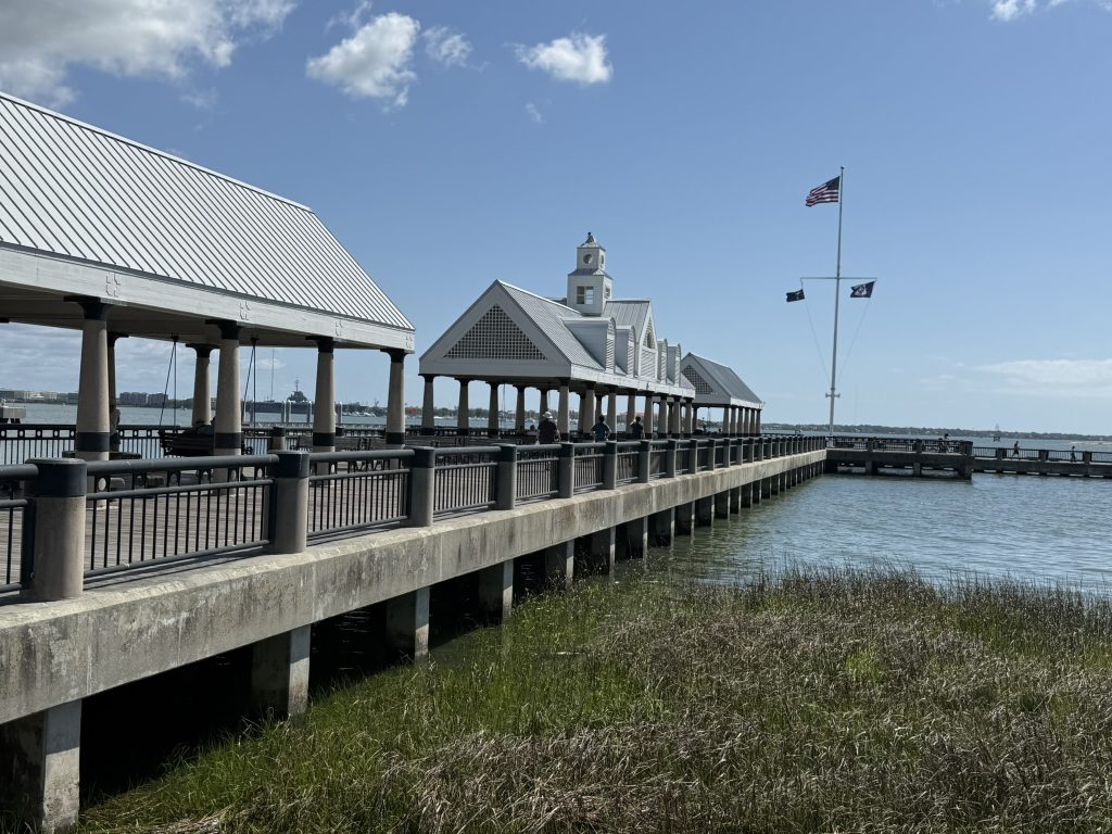 In downtown Charleston, South Carolina, Waterfront Park pier and bridge with swings leading out over the water of Charleston's harbor