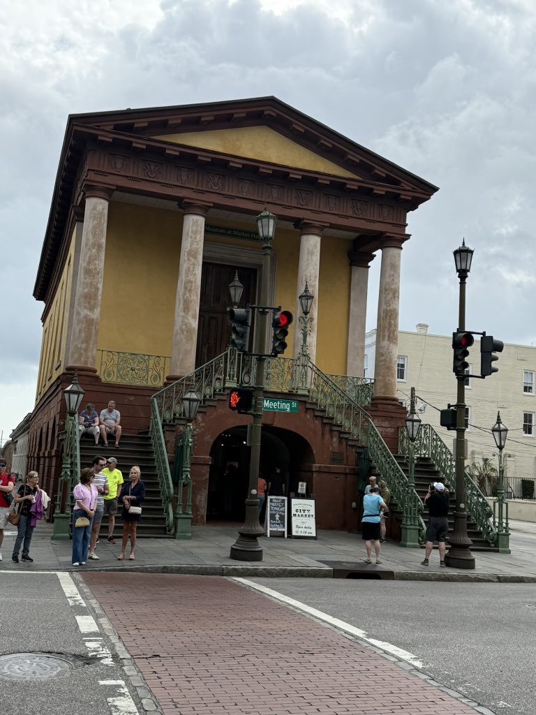 Meeting street entrance to Chareston's City Market. An old brick building built a level up off the ground, with an entrance to the market stalls underneath.