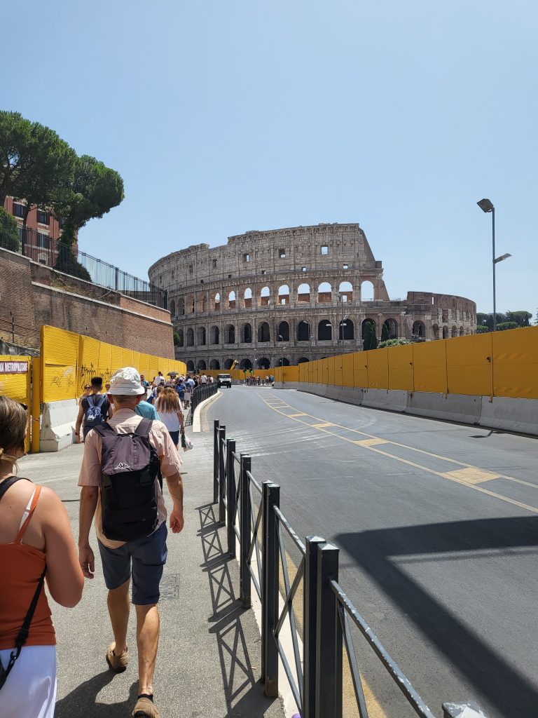 Walking towards the Colosseum with tourists in front of us when we were decided how many days in Rome, Italy