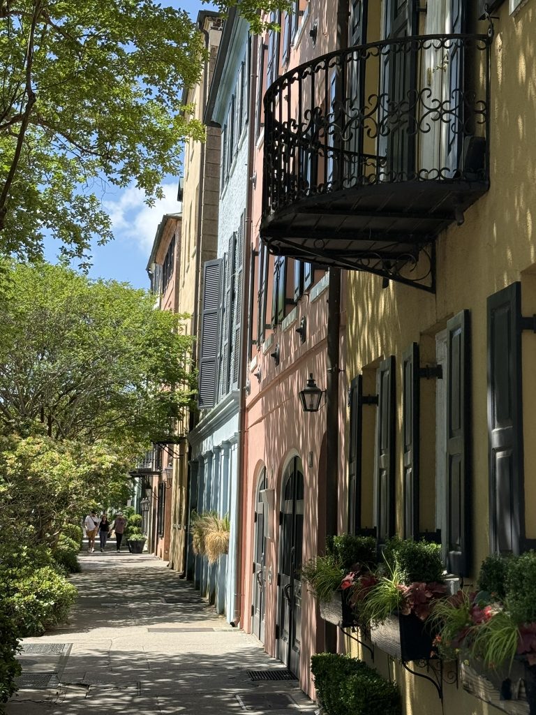 Rainbow Row in Charleston, South Carolina seen in October with bright yellow, pink and blue houses lined up together
