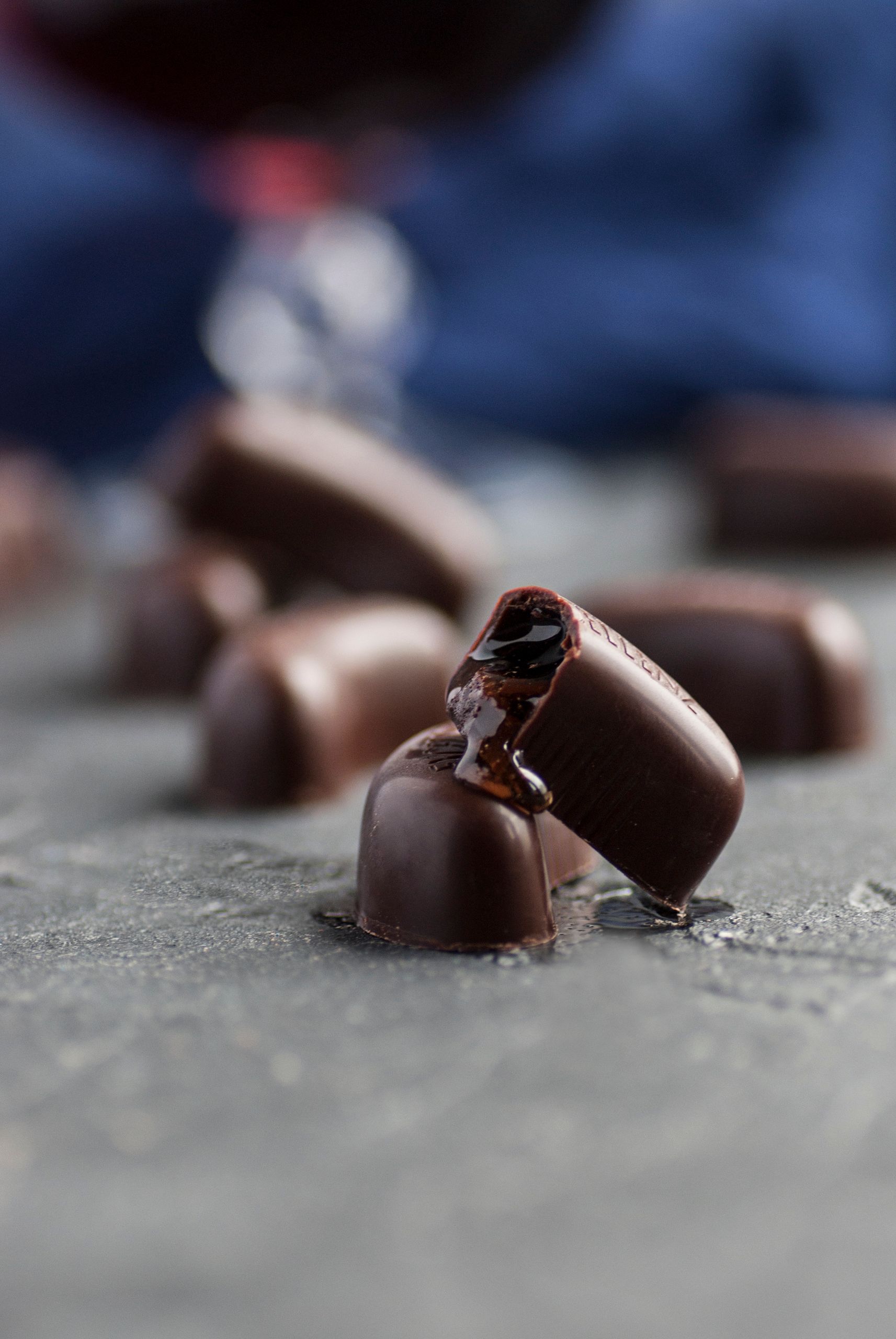 Mouth-watering close-up of bite-sized chocolate pralines melting on a surface.