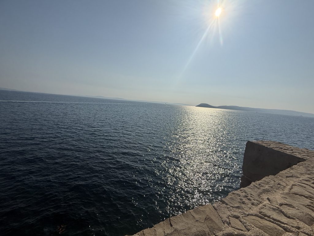 Sun sparkling on the Adriatic from the rocky coastline on a tuk tuk tour in Split