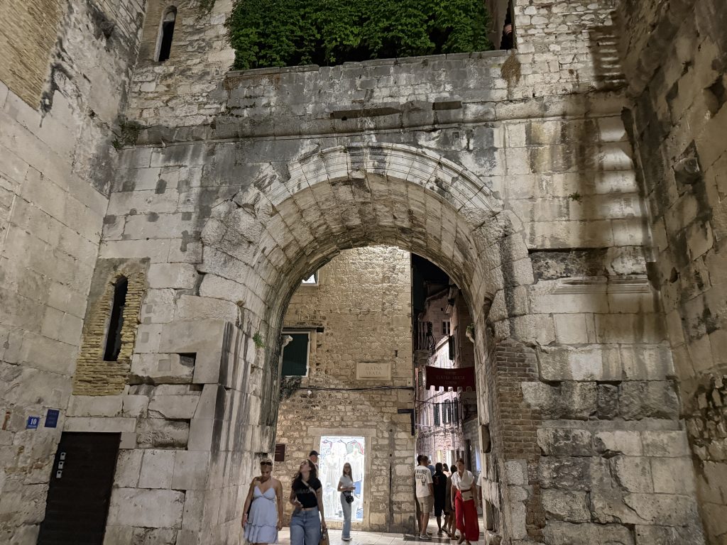 The Golden Gate of Diocletian's Palace lit up at night in Split's Old Town