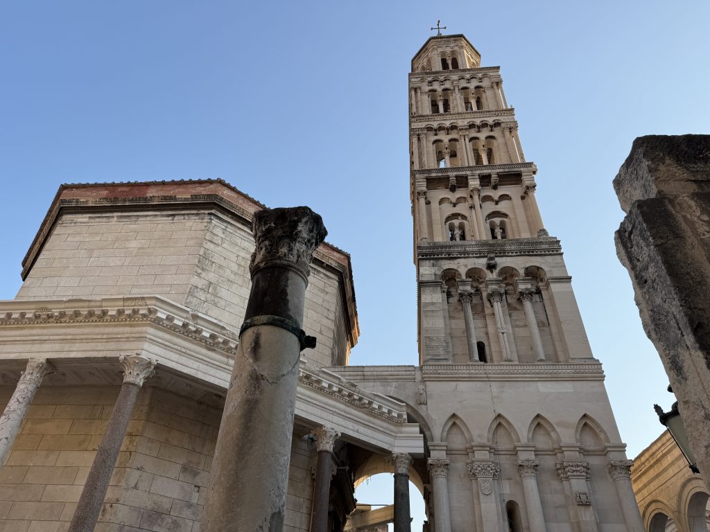 Bell tower of the Cathedral of St. Domnius rising above Roman columns in Split