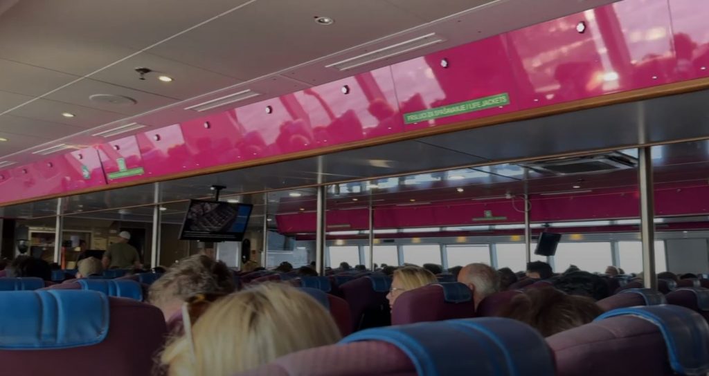 Full enclosed cabin of the Krilo catamaran from Split to Hvar, with rows of passengers and a snack counter at the back