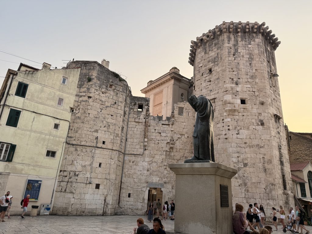 Marko Marulić statue and the Venetian tower on Fruit Square in Split at dusk