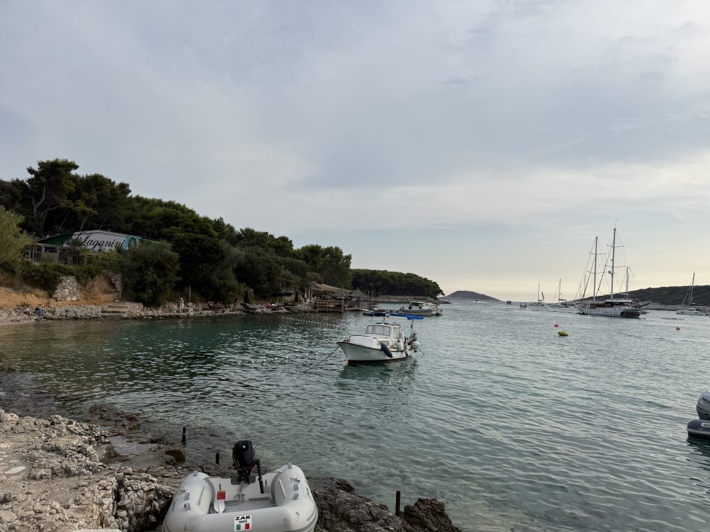 View from beach looking out at water at Vinogradišće Bay’s harbor at a stop on a Blue Cave tour from Hvar