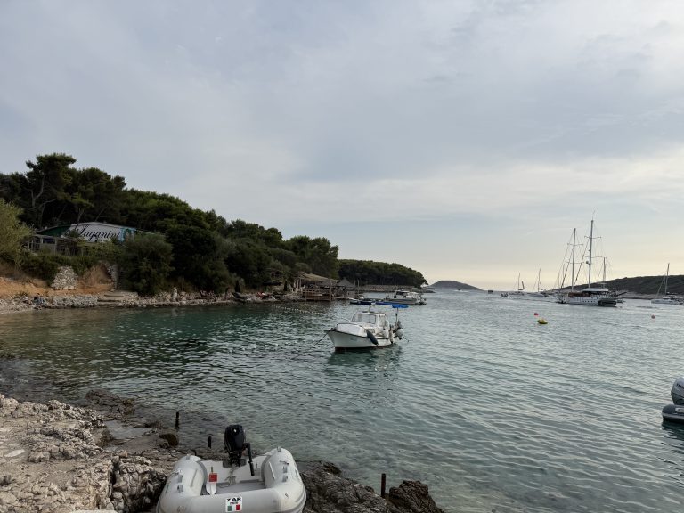 View from beach looking out at water at Vinogradišće Bay’s harbor at a stop on a Blue Cave tour from Hvar