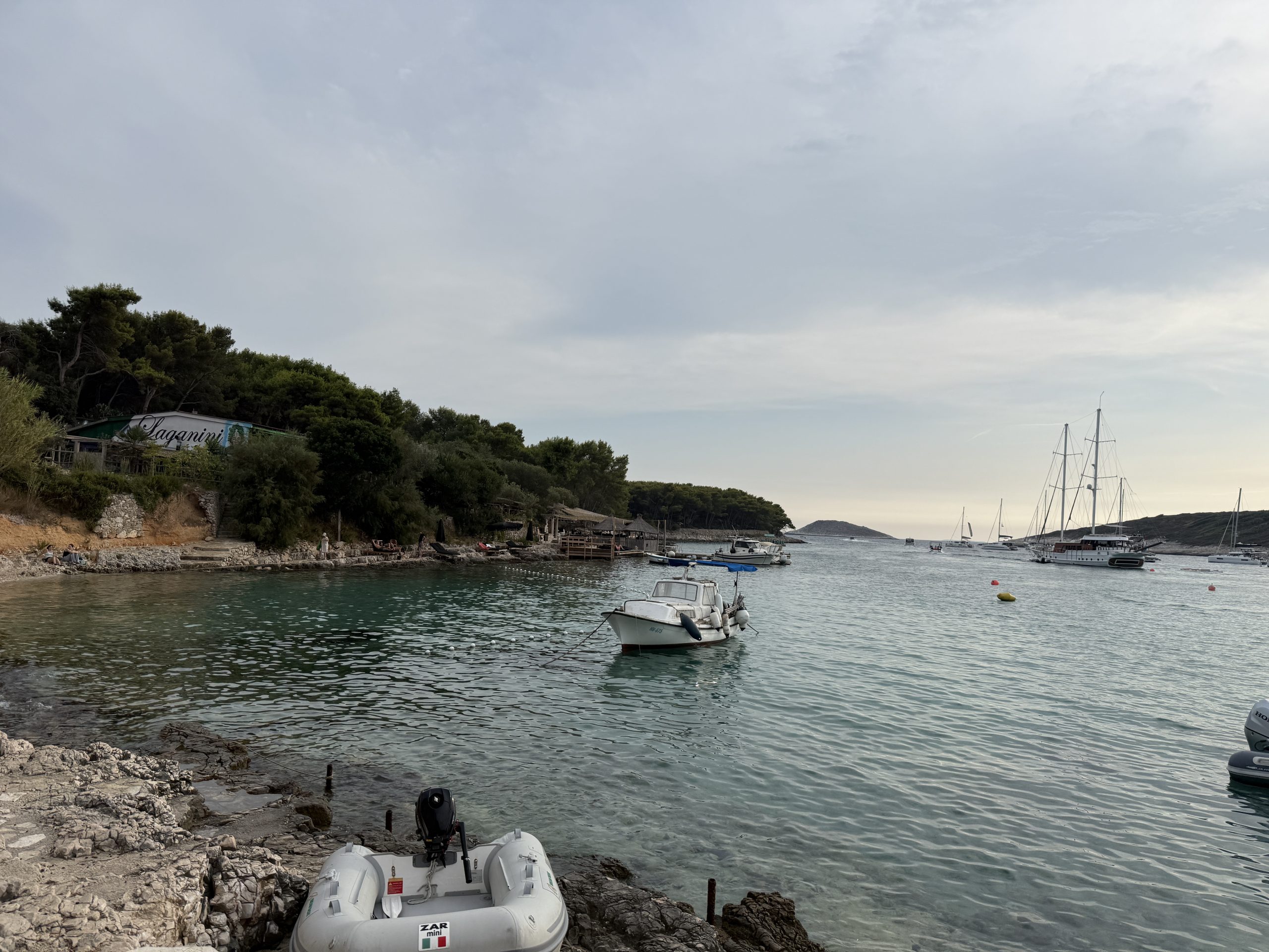 View from beach looking out at water at Vinogradišće Bay’s harbor at a stop on a Blue Cave tour from Hvar